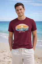 Man wearing tropical turtle sunset t-shirt on beach, summer vacation outfit, ocean graphic tee