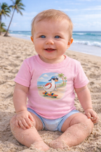 Baby girl wearing pink duck skateboard t-shirt sitting on beach, cute summer outfit for kids matching family clothing